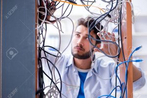 Computer repairman working on repairing network in IT workshop